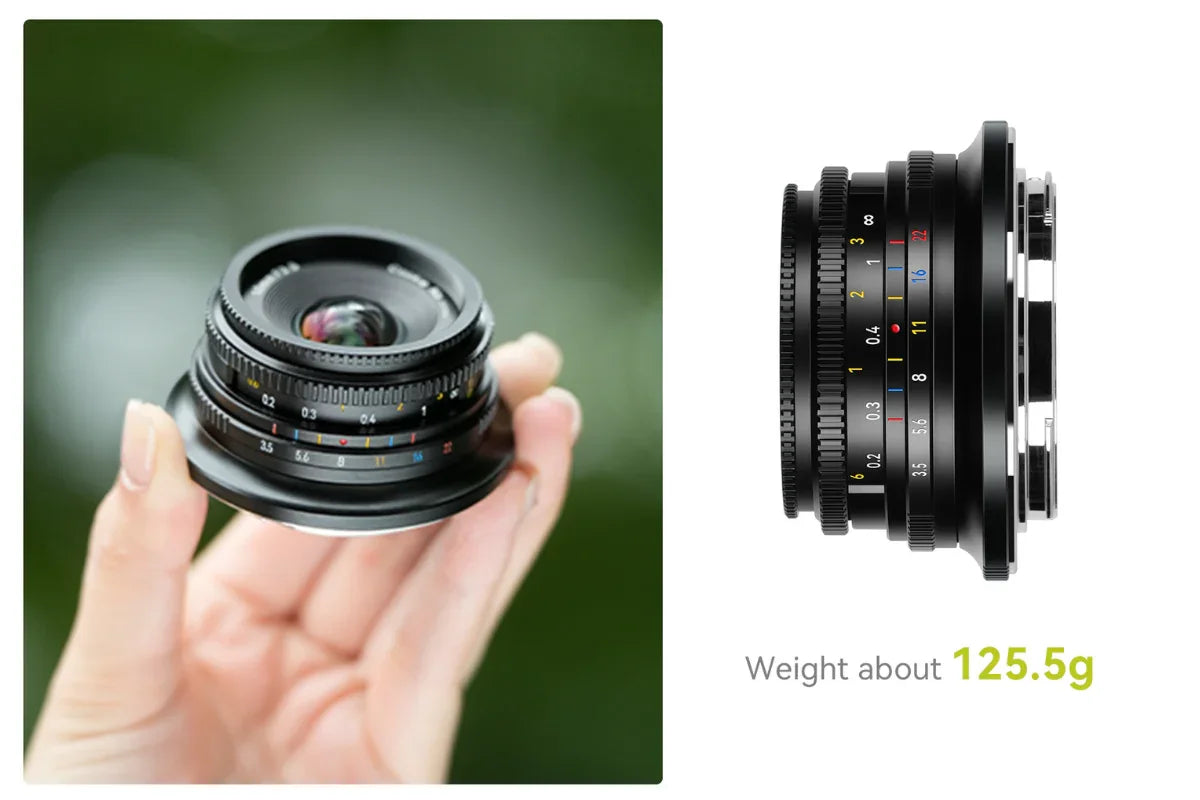 Compact black camera lens held in hand with markings and weight 125.5g on white background