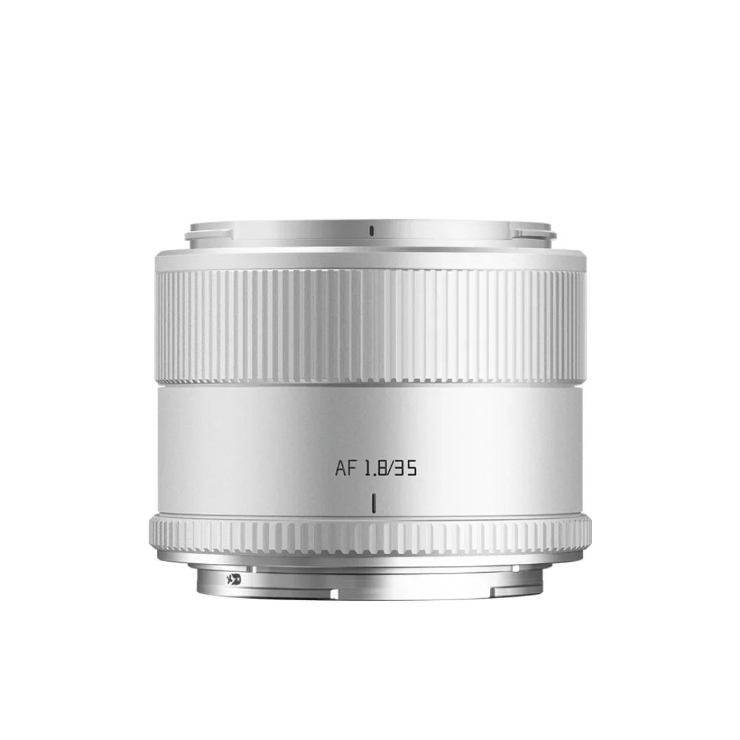 Silver AF 1.8/35 camera lens with ribbed focus and aperture rings isolated on white