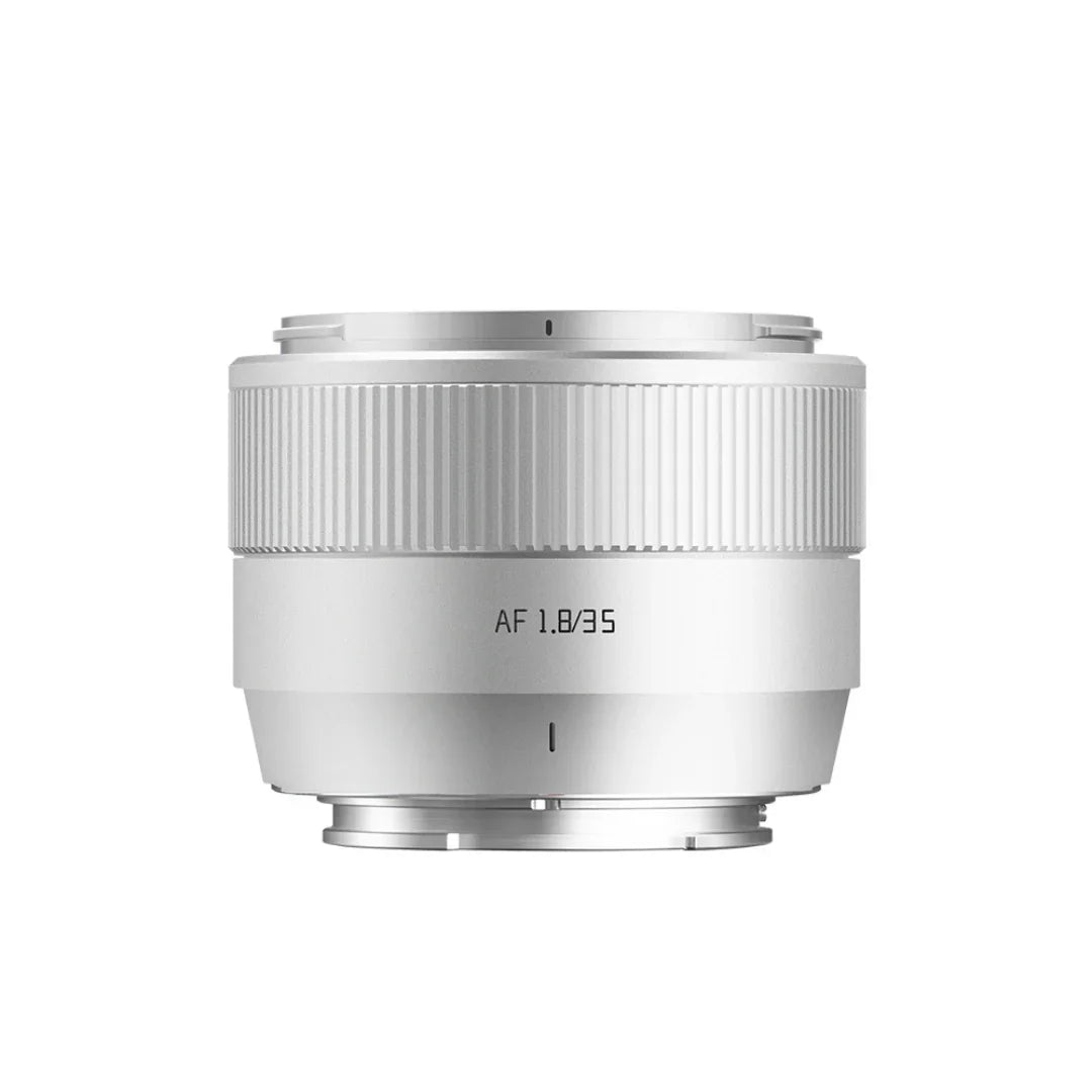 White 35mm f1.8 autofocus camera lens with ribbed focus ring on white background