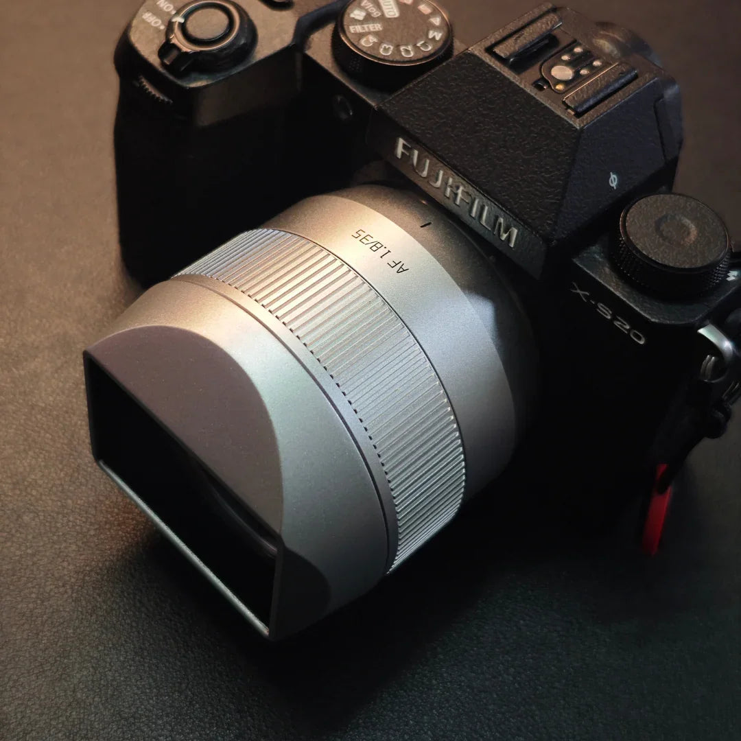 Fujifilm X-S20 camera with silver AF 18-35mm lens on dark textured surface