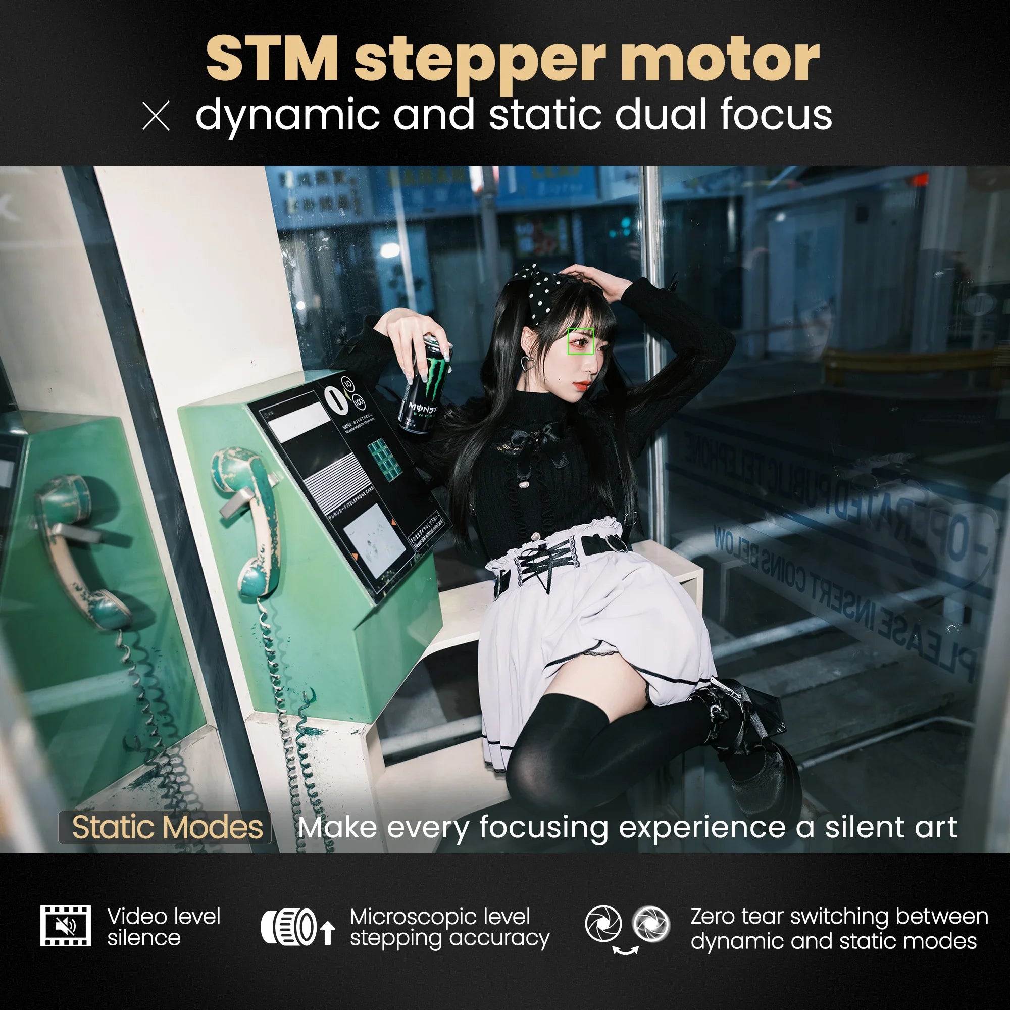 Young woman in black and white outfit posing with can near vintage green payphone inside glass booth at night